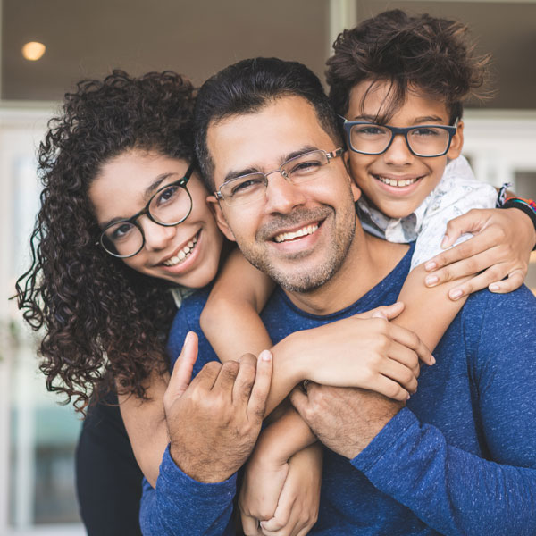 father smiling with two children