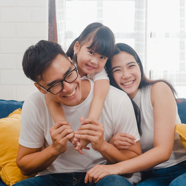 smiling family of three